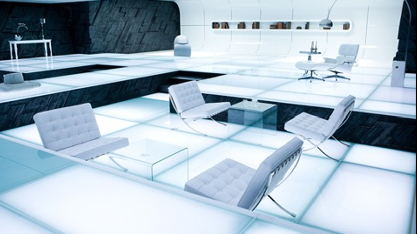 White leather Knoll Barcelona chair in Tron: Legacy (2010). Also in this set is the 670 lounge and ottoman by Charles and Ray Eames, and the Arco lamp by Achille Castiglioni. Image: Disney Enterprises.