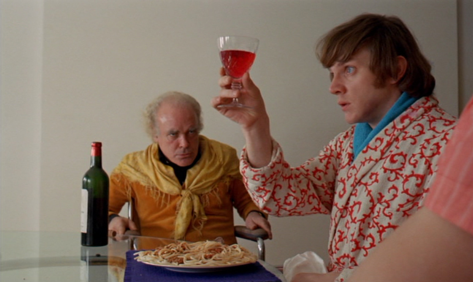 Alex eats spaghetti and drinks red wine at Mr Alexander's dining table in HOME in A Clockwork Orange